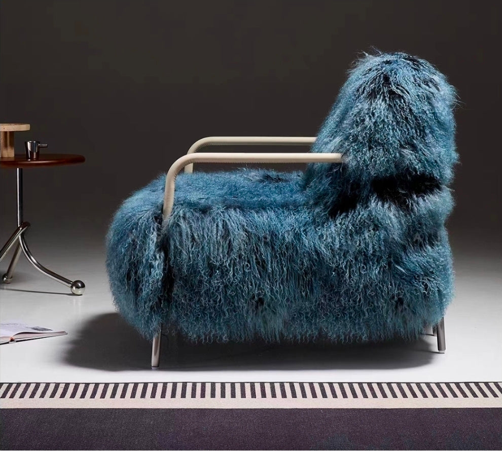 Sculptural shearling armchair with leather-wrapped armrests and black steel legs
