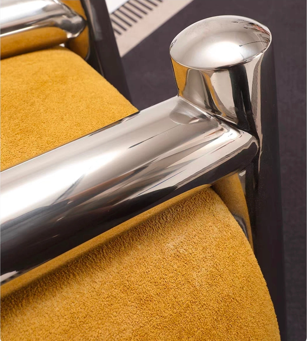 Polished stainless steel base detail on sculptural armchair