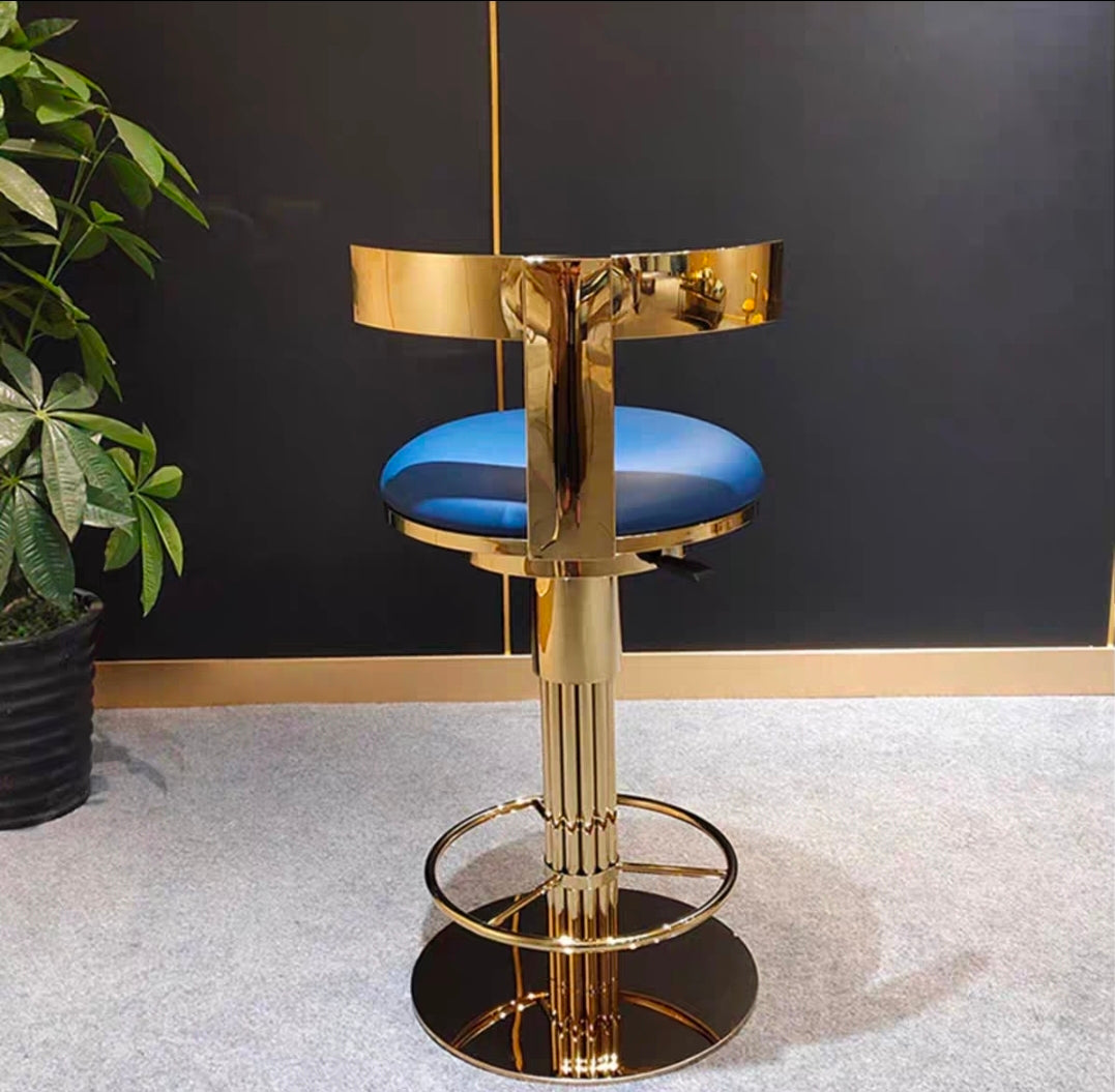 Sculptural brass-finish bar stool with upholstered seat