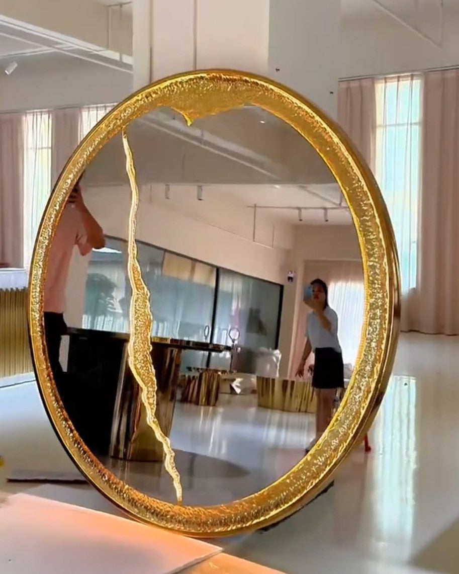 Round wall mirror with sculpted gold frame